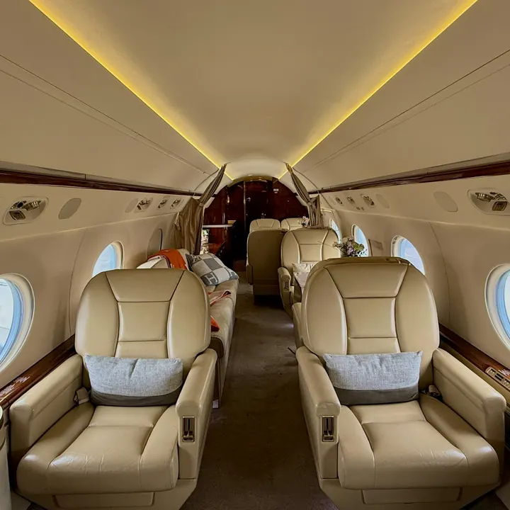 Warm light across the seats of a private jet cabin
